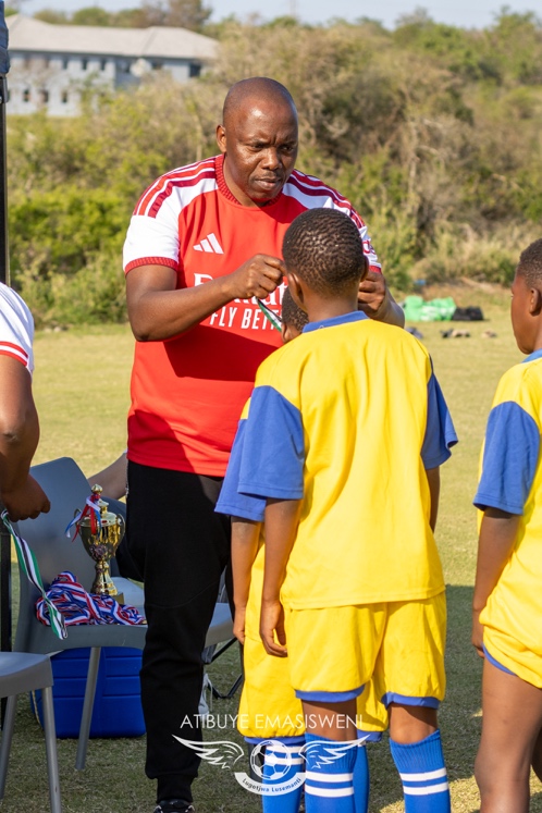 [PHOTO: Evelyn Baring Primary School players Getting their Silver Medals presented by Sifiso Malinga (Africivils)